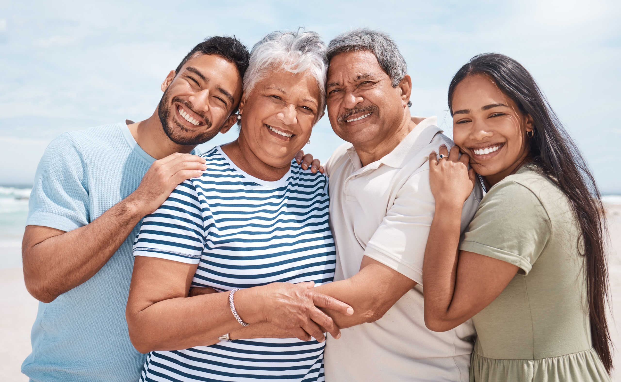 shot of a senior couple at the beach with their children