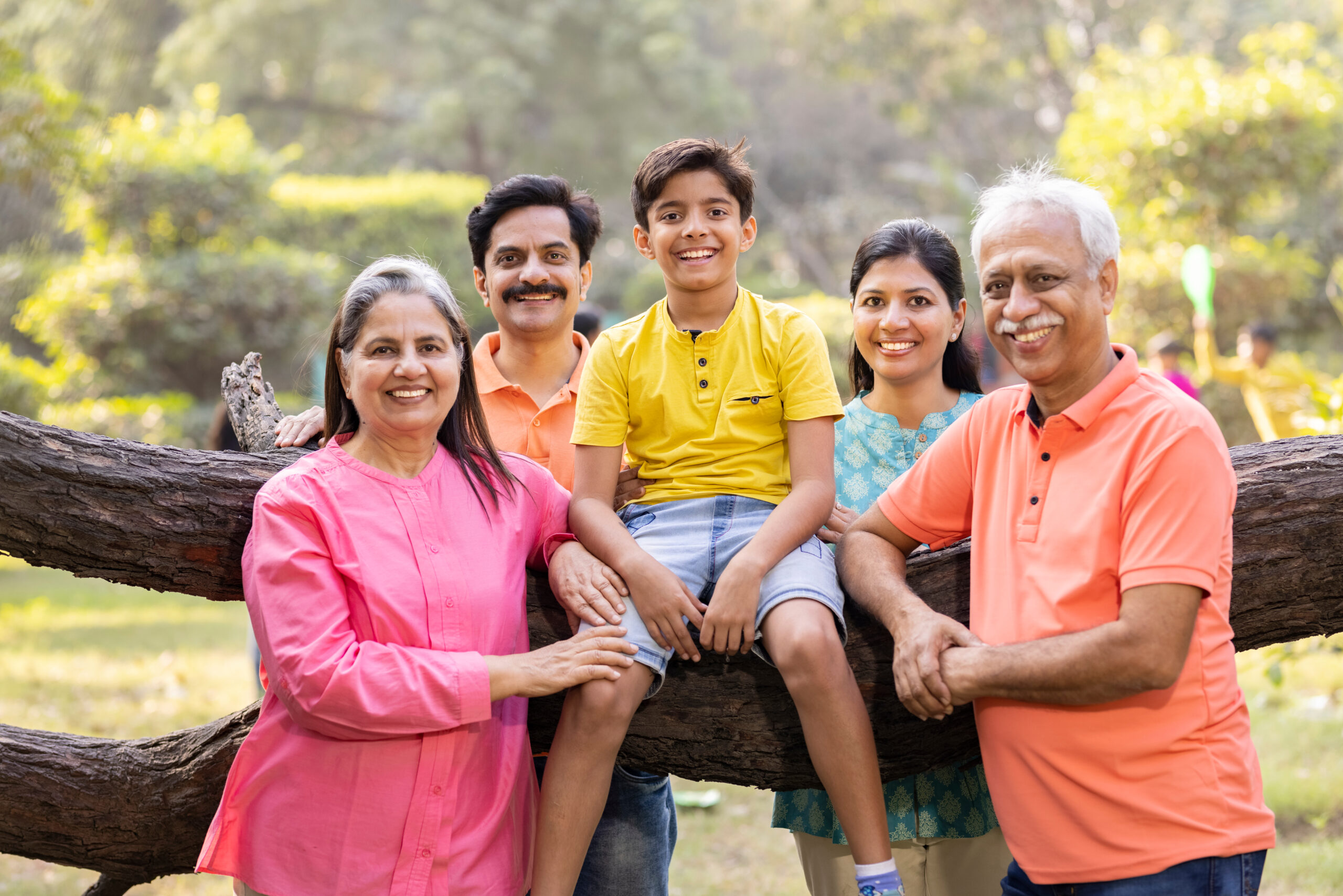 group of happy people with senior citizens at park.