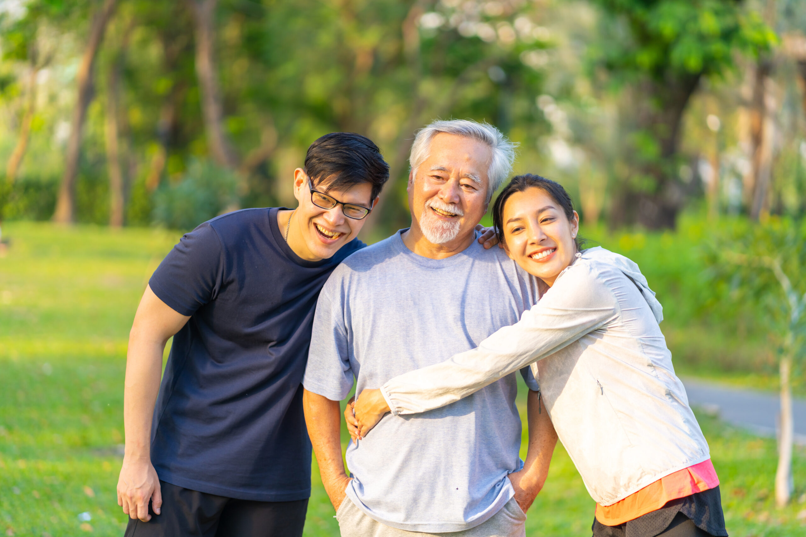 portrait of asian couple and elderly father jogging exercise together at park.