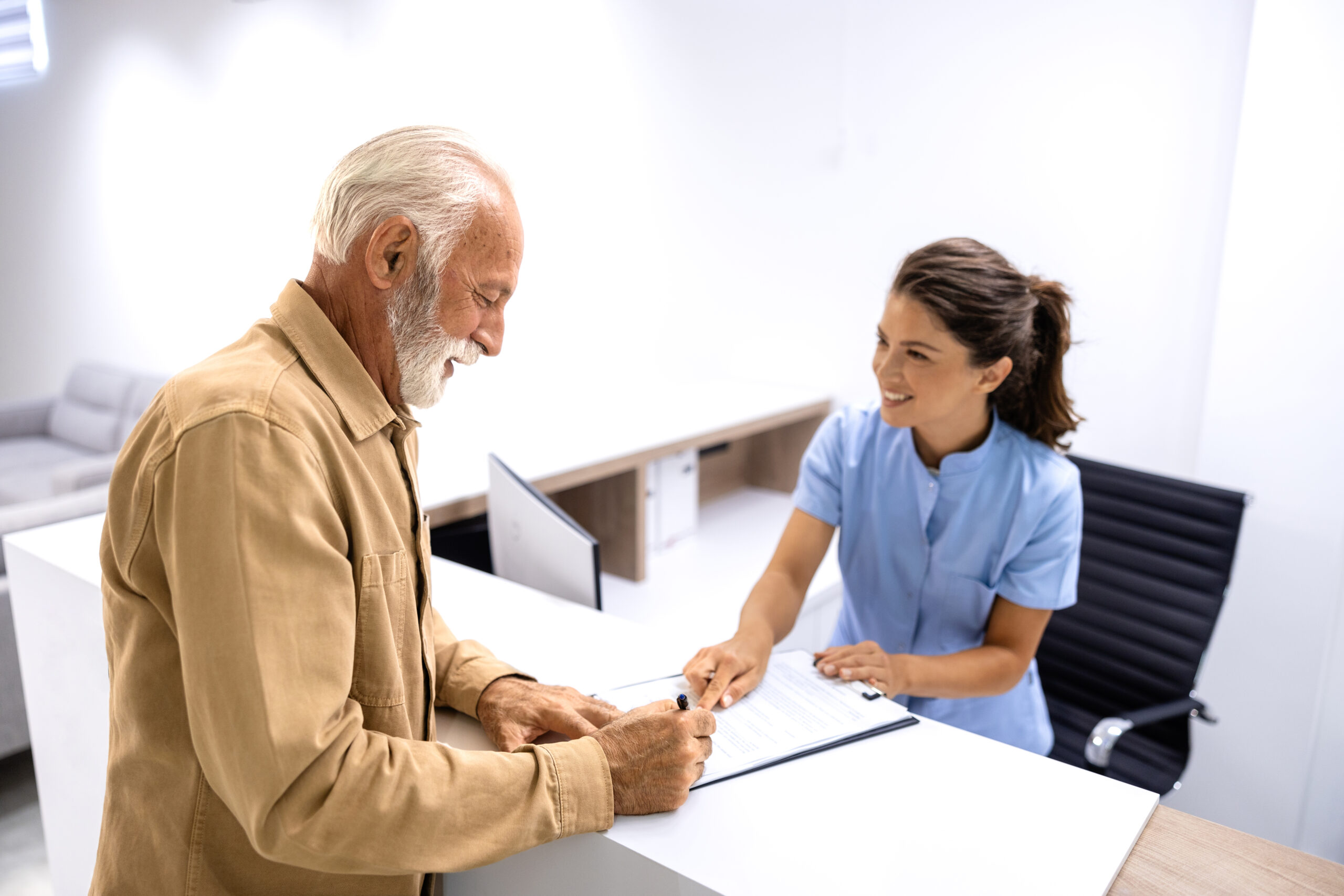 patient signing document in hospital.