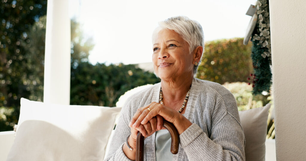 thinking, senior and woman with disability at house of happy memory, nostalgia and past reflection. smile, disabled person and relax with thoughts, retirement planning and remember life in backyard