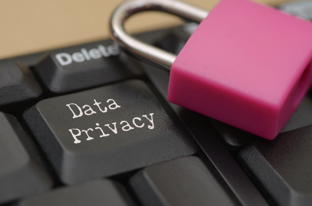 computer keyboard with data privacy key and pink padlock symbolizing cybersecurity